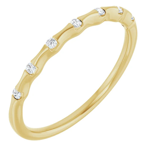Gold ring with small diamonds on a white background