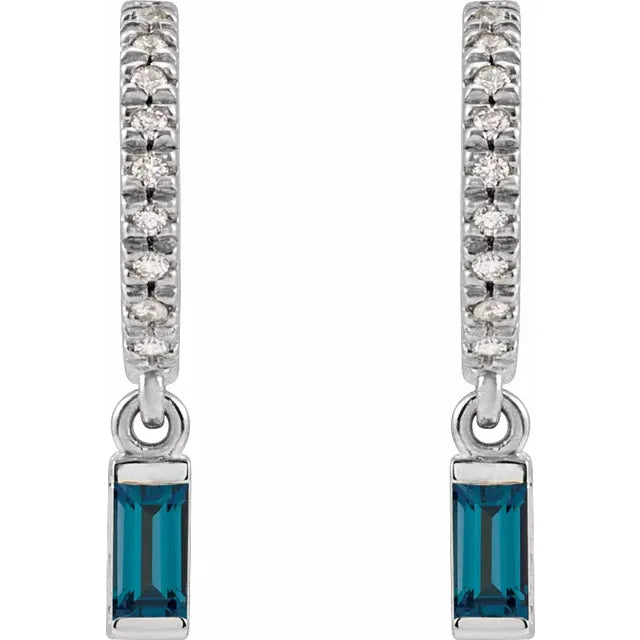 Pair of earrings with blue gemstones and diamond-studded hoop designs on a white background