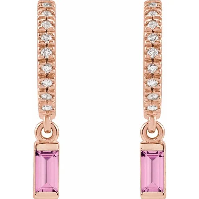 Rose gold earrings with pink gemstones on a white background