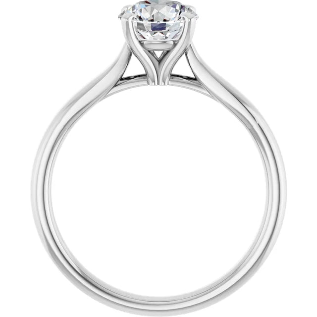 Classic 4-prong round solitaire engagement ring in 14K white gold with a 1 carat diamond, timeless Tiffany-style design.