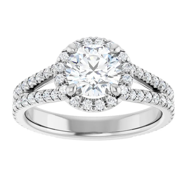 Round diamond engagement ring with French-set accents and a split shank band set in Platinum