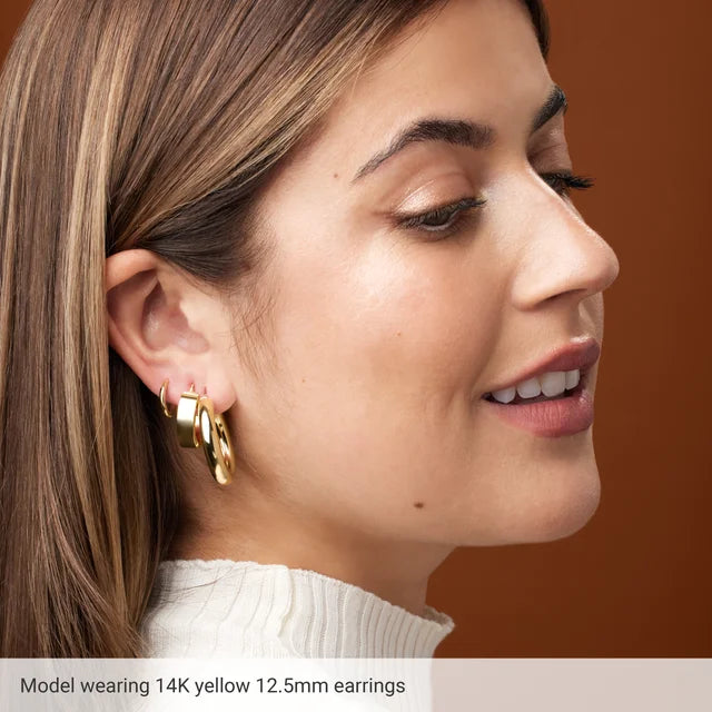 a model wearing a hinged hoop earrings 