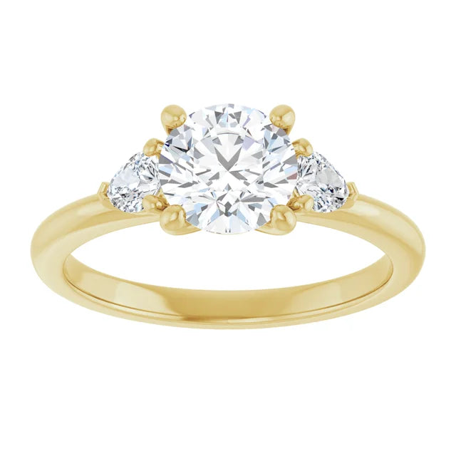 1 1/4 CTW Three-stone diamond engagement ring with round center and pear-shaped side stones 