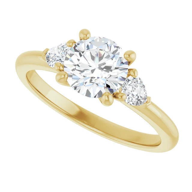 1 1/4 CTW Three-stone diamond engagement ring with round center and pear-shaped side stones in Yellow Gold
