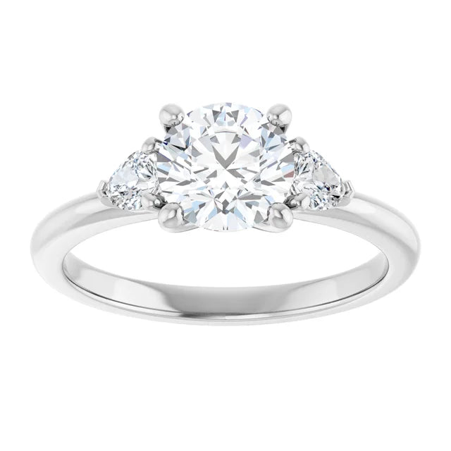 1 1/4 CTW Three-stone diamond engagement ring with round center and pear-shaped side stones in Platinum
