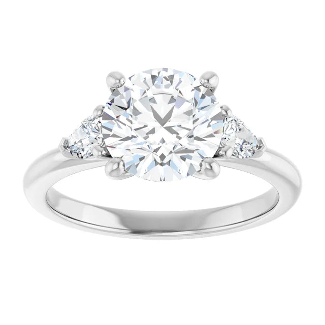 2 1/4 CTW Three-stone diamond engagement ring with round center and pear-shaped side stones in Platinum