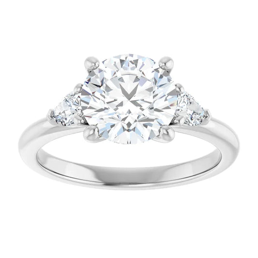 2 1/4 CTW Three-stone diamond engagement ring with round center and pear-shaped side stones in Platinum