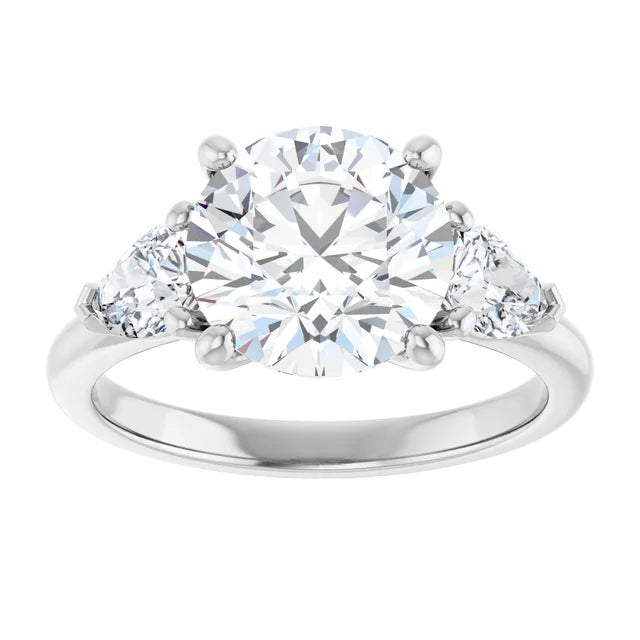 3 1/4 CTW Three-stone diamond engagement ring with round center and pear-shaped side stones in Platinum 
