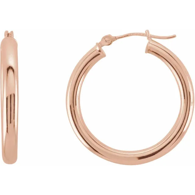 25 mm bold round tube hoop earrings in polished 14K rose gold with 3 mm thickness and catch closure
