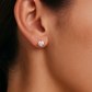 Close-up of a woman's ear wearing a 5 MM round diamond stud earring in a yellow gold 3-prong martini setting (1 CTW total)