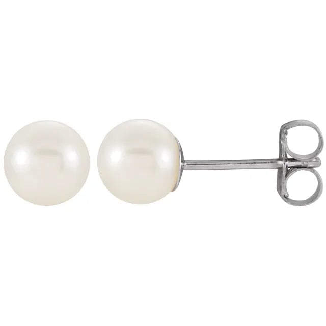 pair of white cultured freshwater pearl stud earrings near round shape with soft luster in white gold