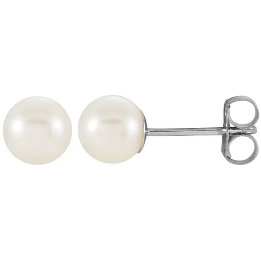 pair of white cultured freshwater pearl stud earrings near round shape with soft luster in white gold